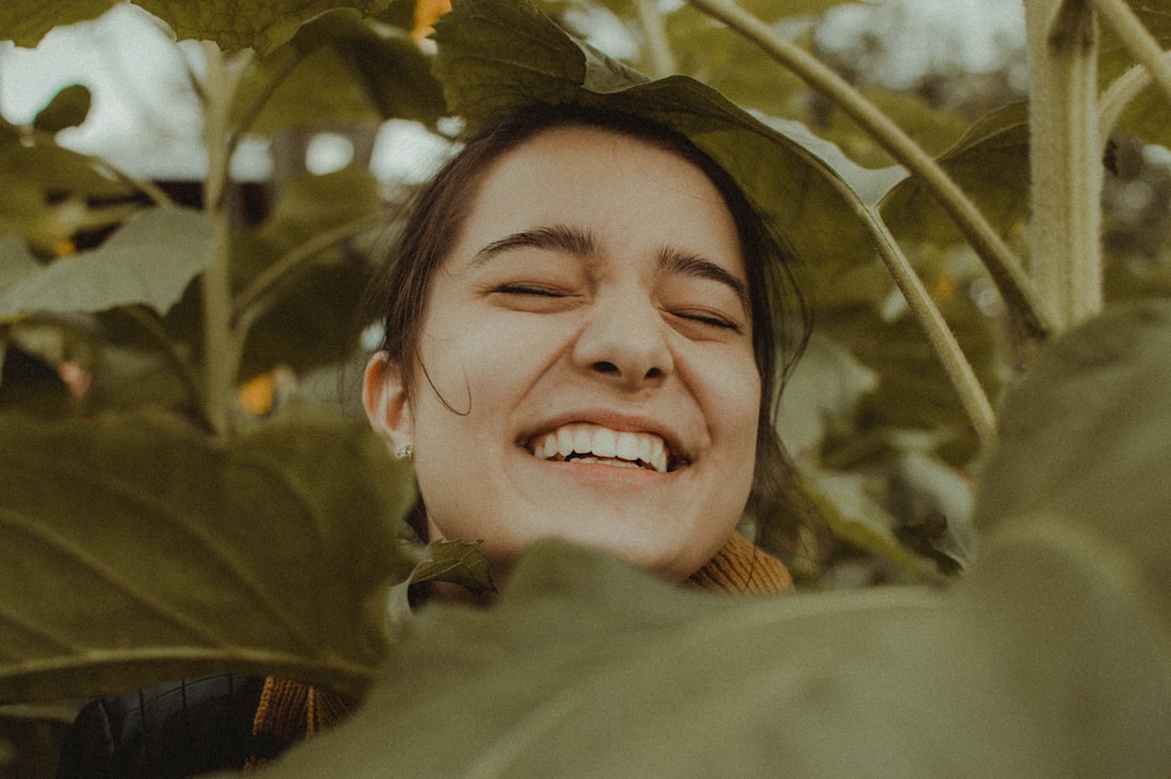 Femme souriante entouree de plantes, bien-etre et nature